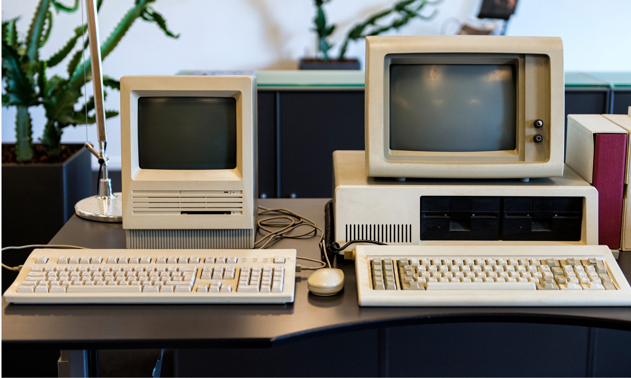 two old computers on a desk